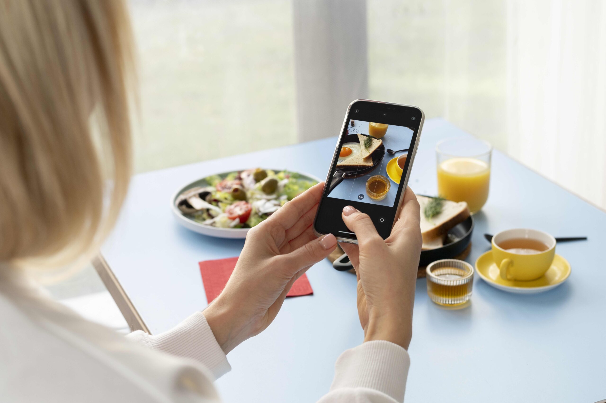 woman-taking-photo-pan-with-egg-toast